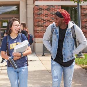 Two students walking with books