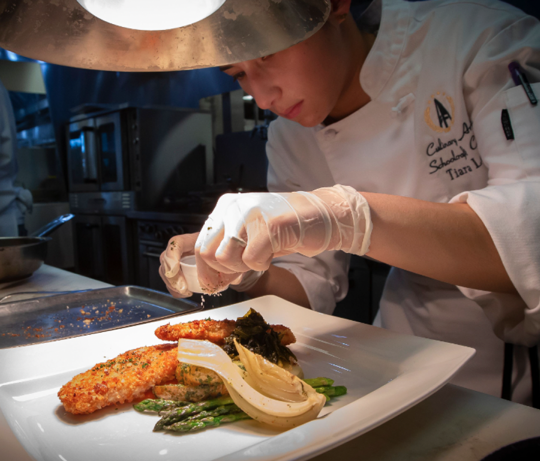 student varnishing a plate