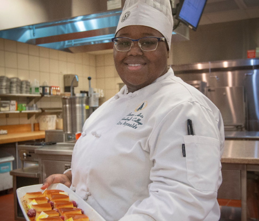 student holding pastry tray