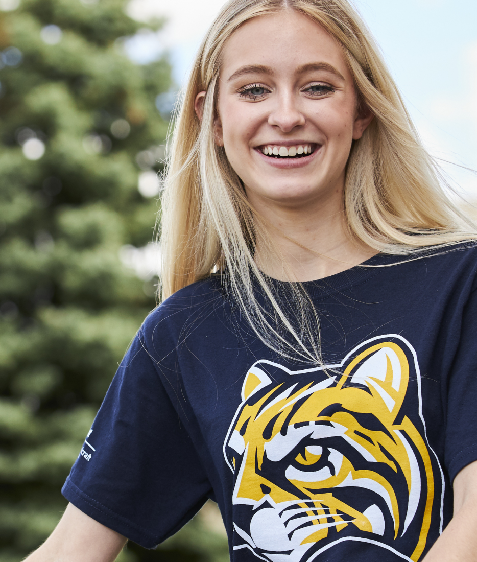 Student smiling, wearing ocelot shirt