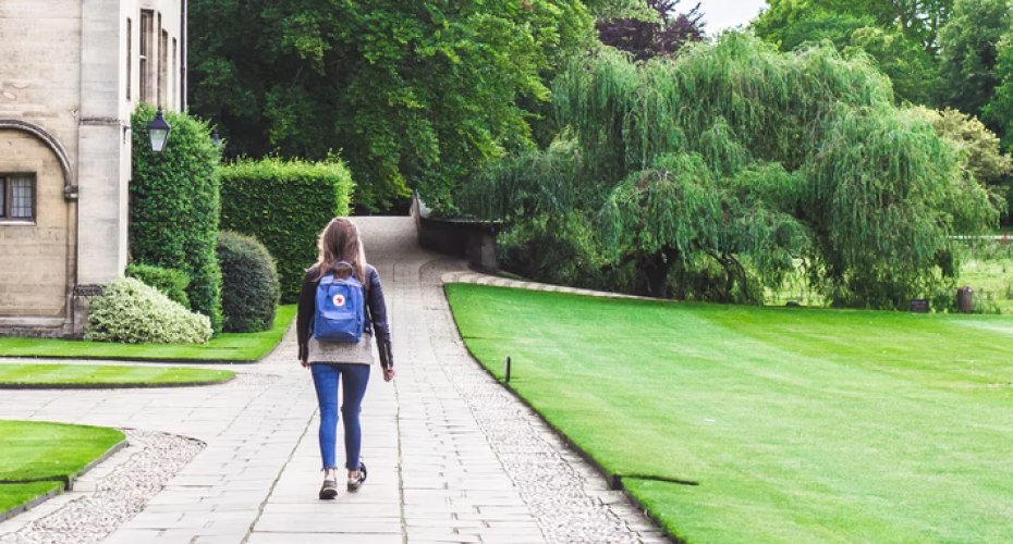 Student walking on an outdoor campus path