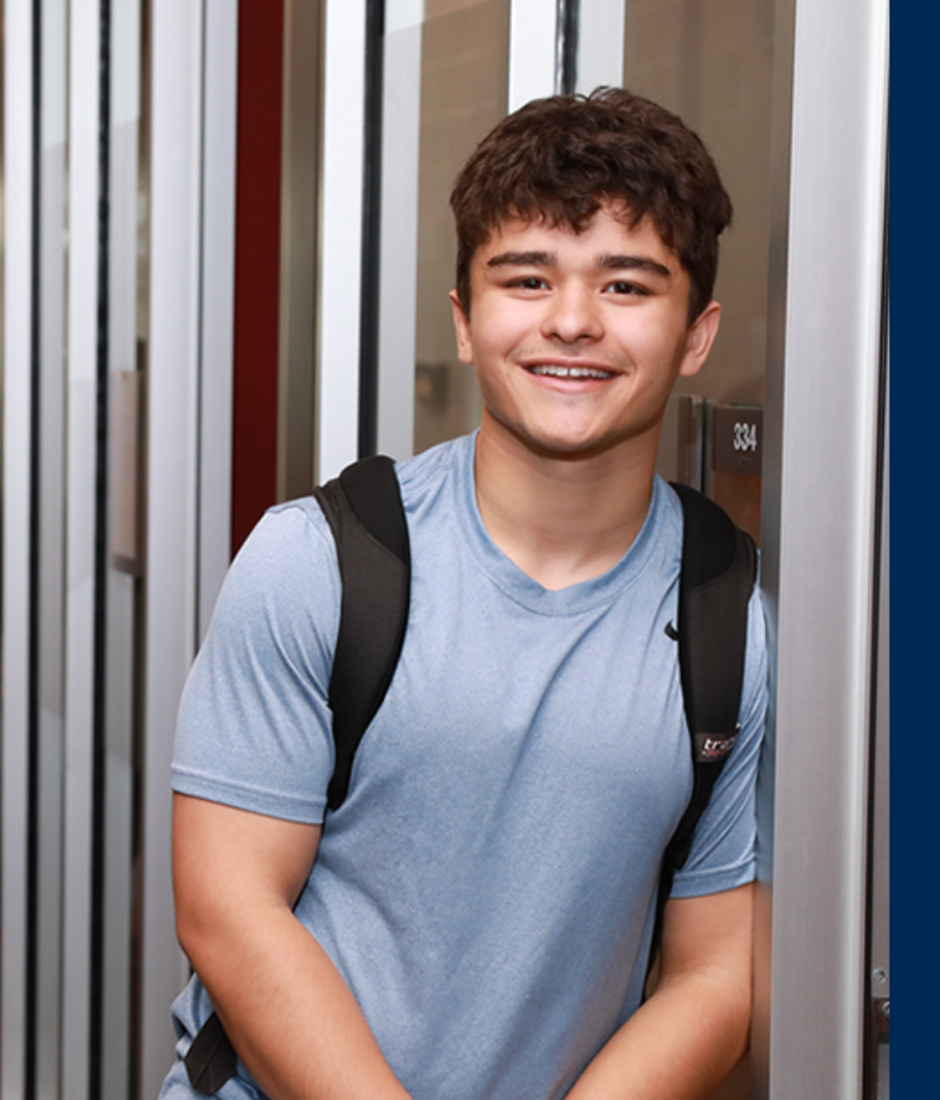 student with backpack smiling