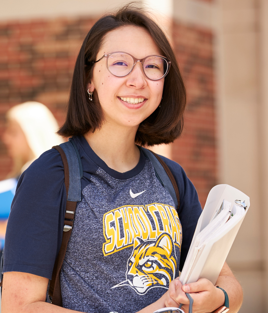 student holding books