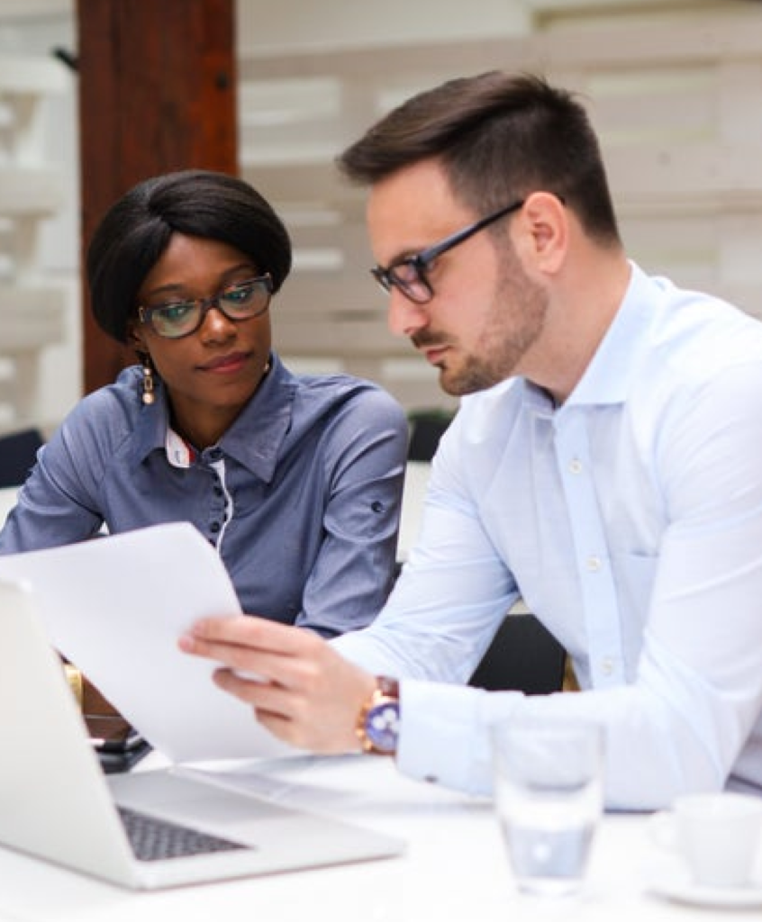 two people reviewing a paper document