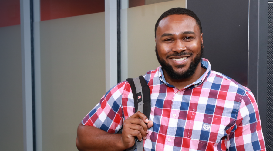 student smiling, wearing backpack