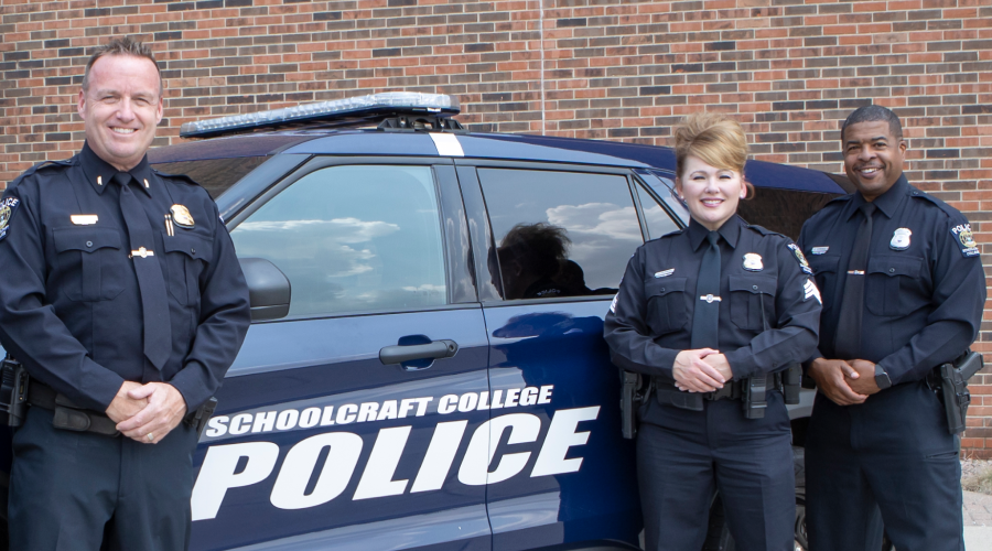 police officers by patrol car