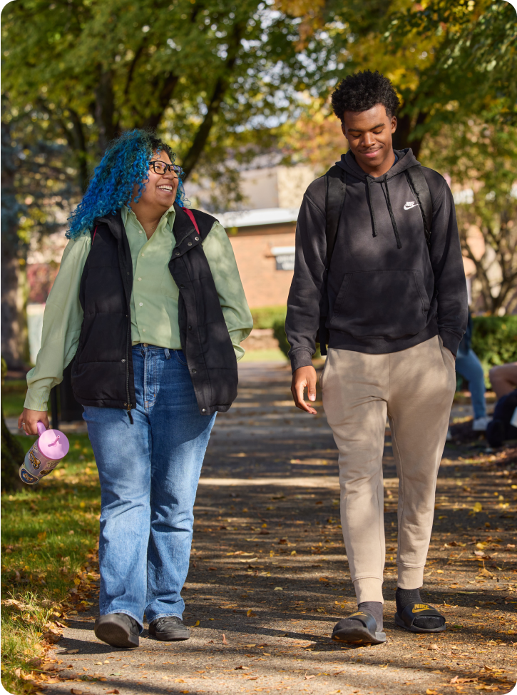 two students walking outdoors spring day