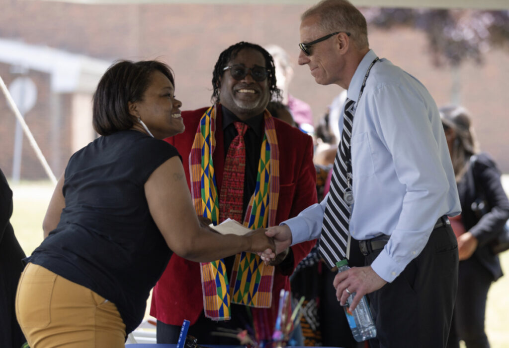 The Schoolcraft College President shaking hands with attendees