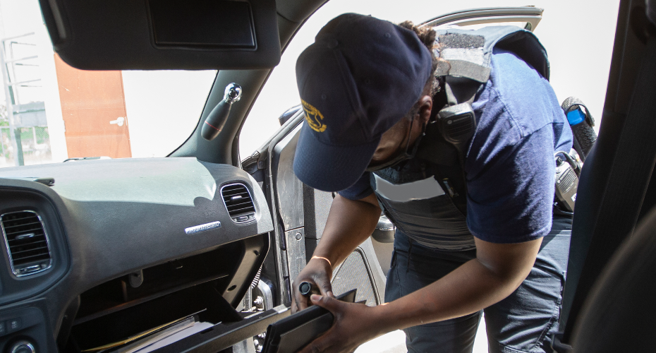 officer searching car compartment