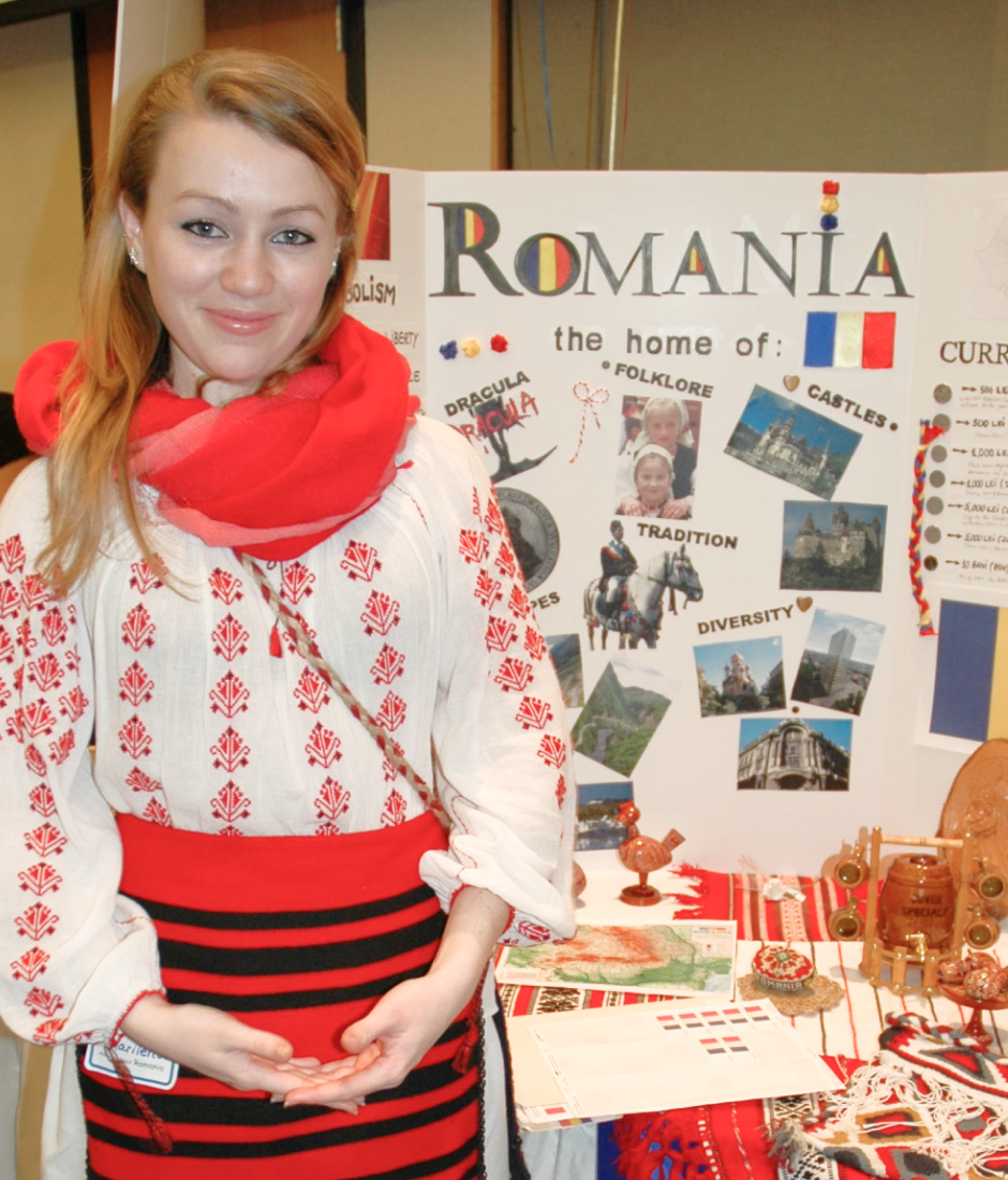 Person next to Romania poster