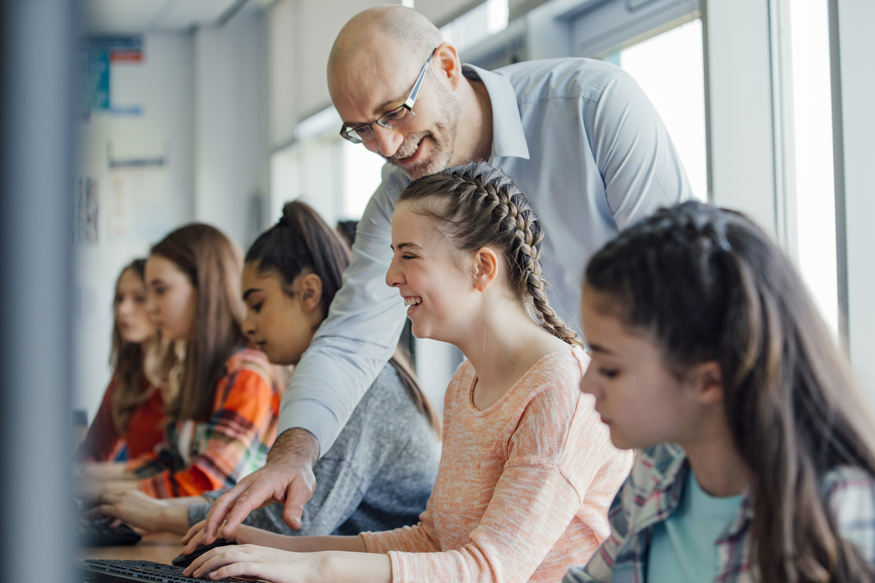 Person helping student at computer