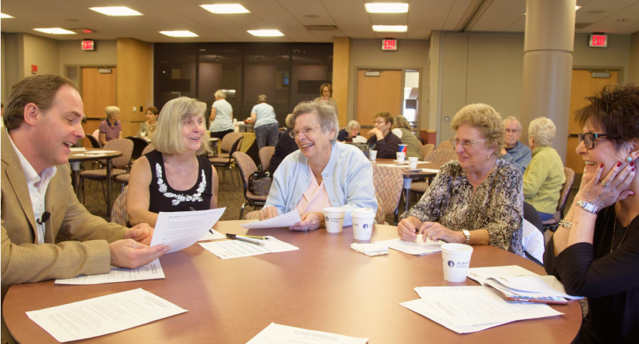 People conversing at a round table