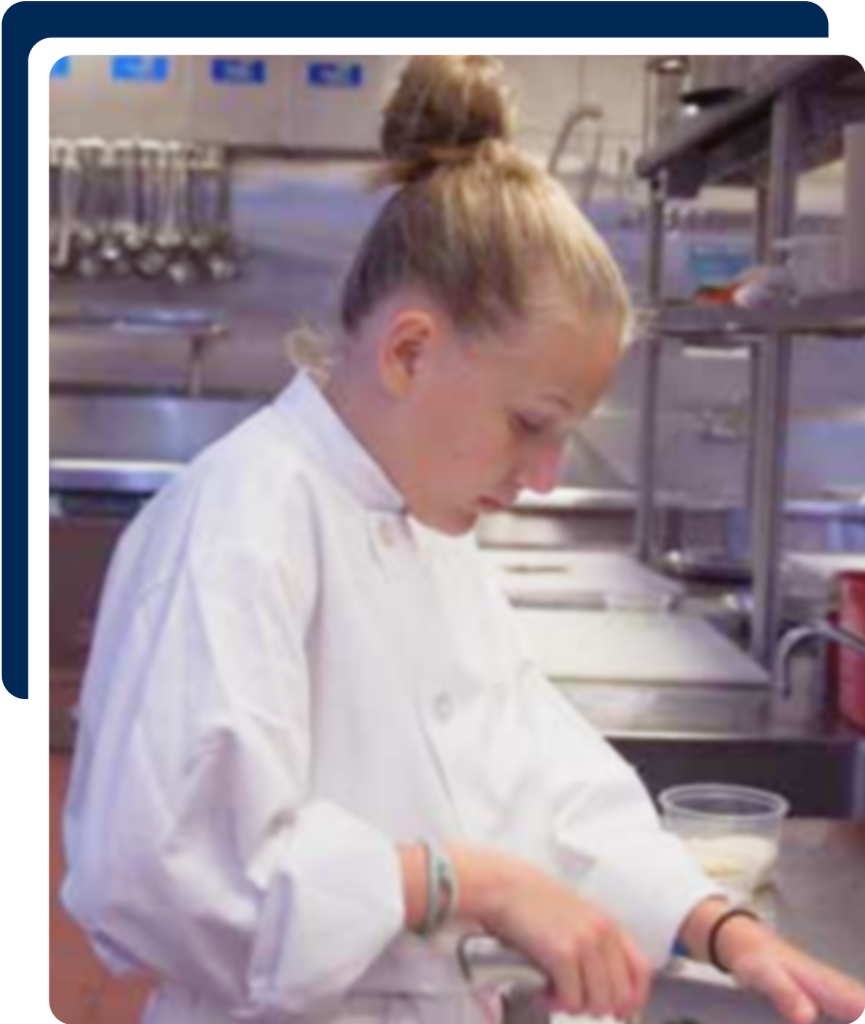 Child chef cutting greens