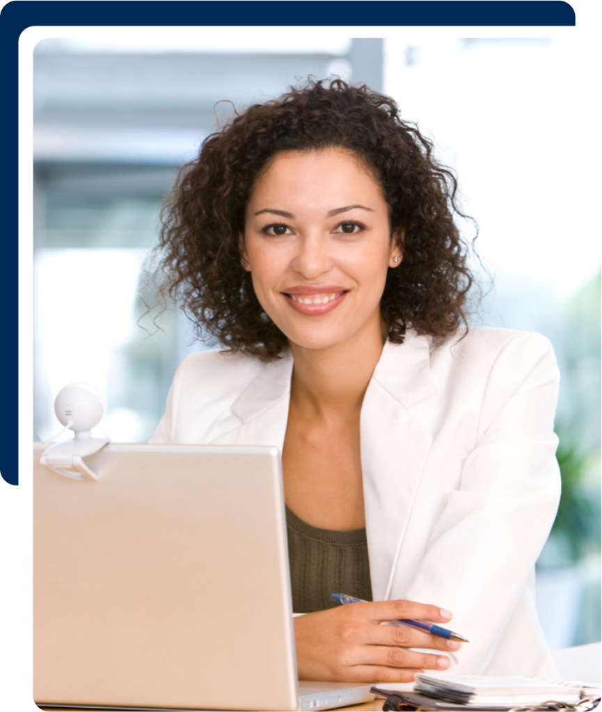 A woman smiling at a work desk