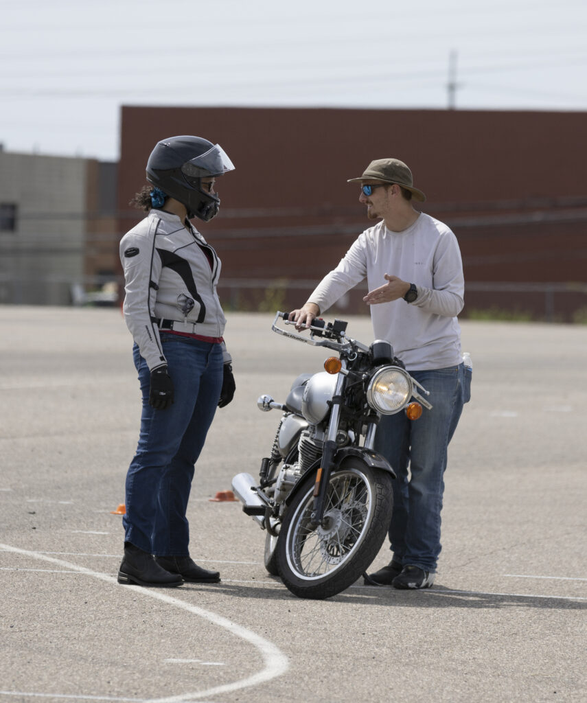 two motorcyclists talking