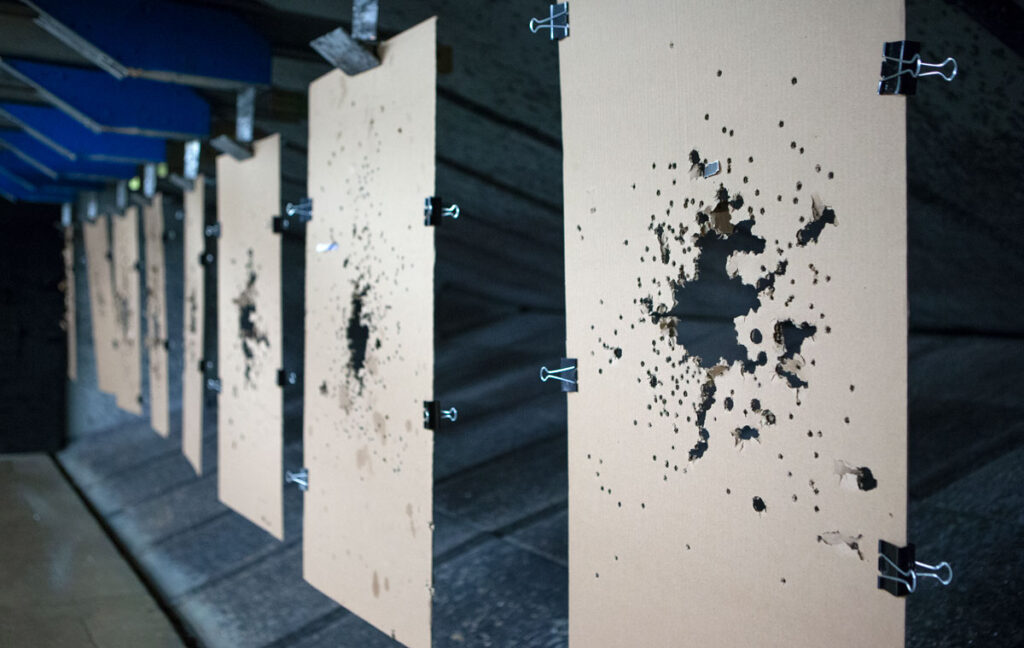 Close up shot of blank targets that have been shot at and covered in bullet holes