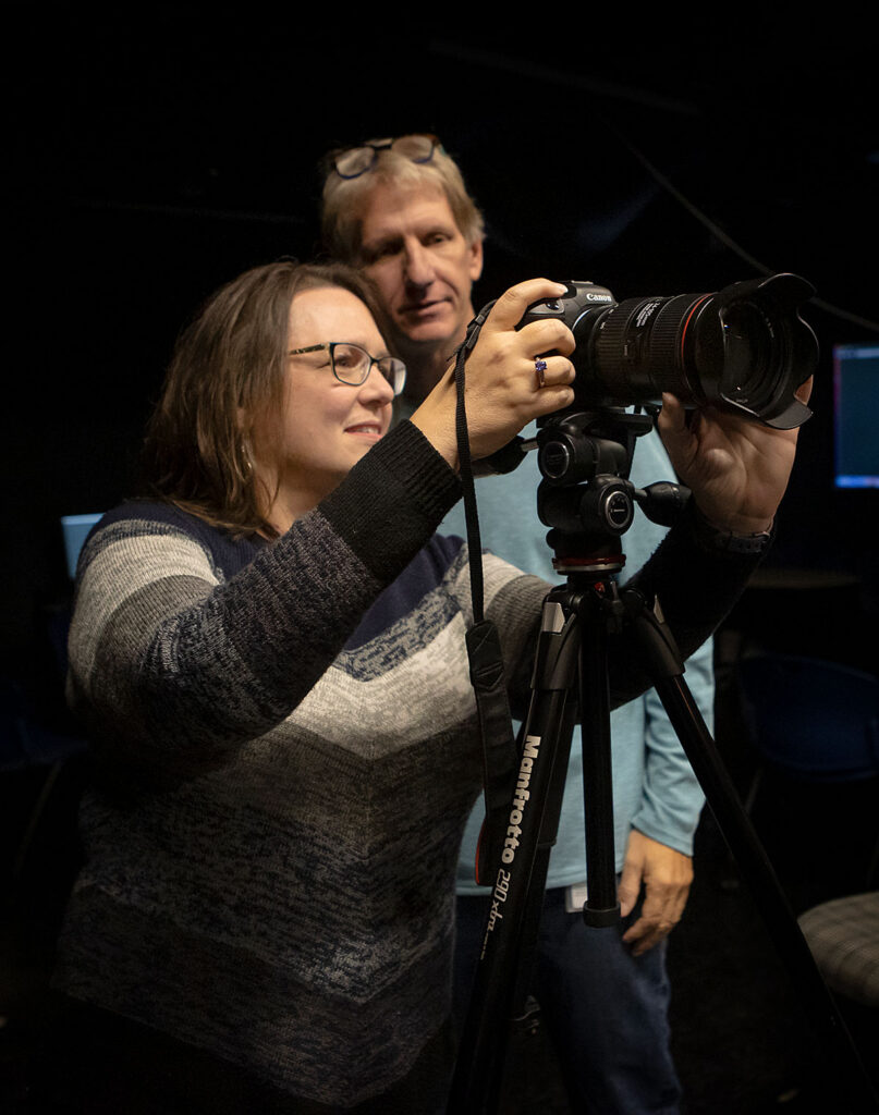 Photographer adjusting camera