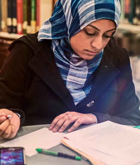 Student reading notes pencil in hand