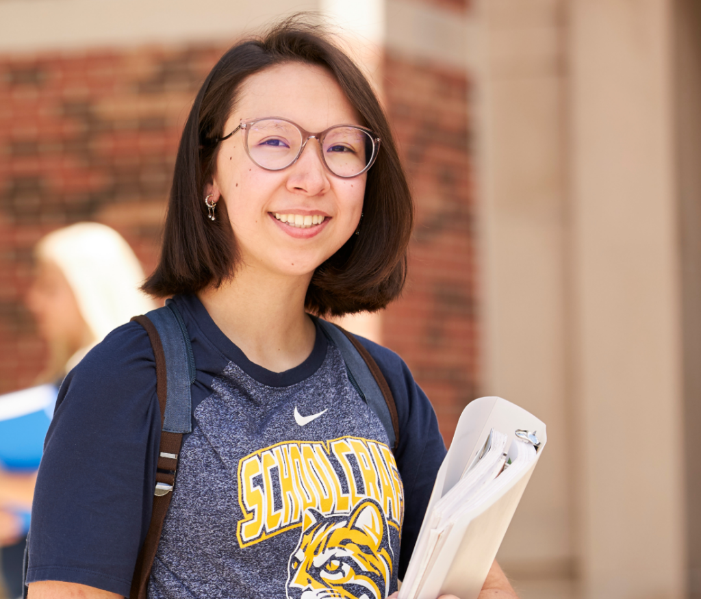 student holding binder