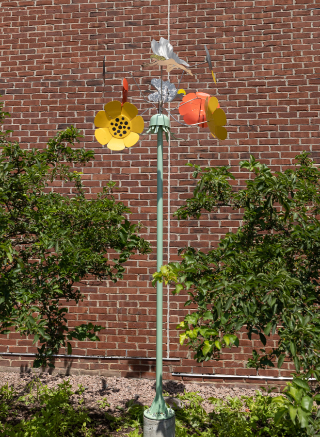 metal sculpture of pole with flowers