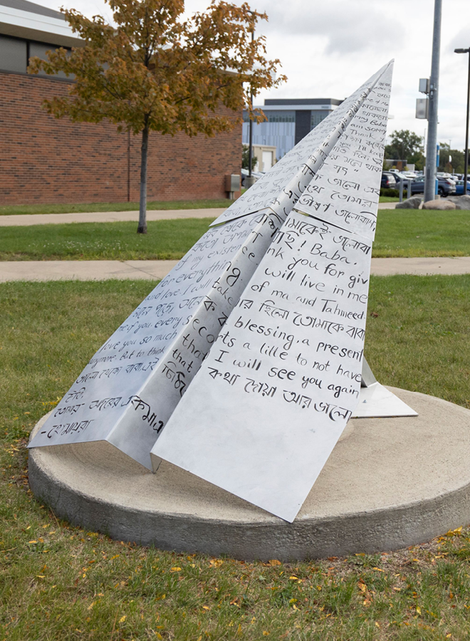 metal sculpture of paper airplane