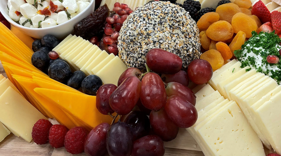 platter of cheeses and grapes