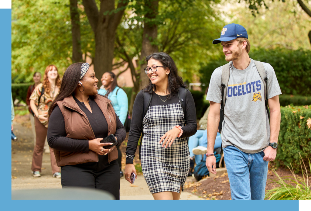 three students walking and talking outdoors