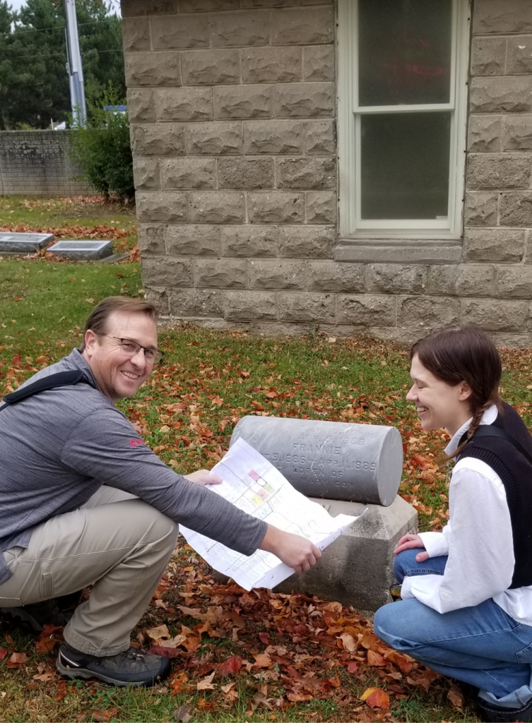 two people looking at paper blueprint outside a building