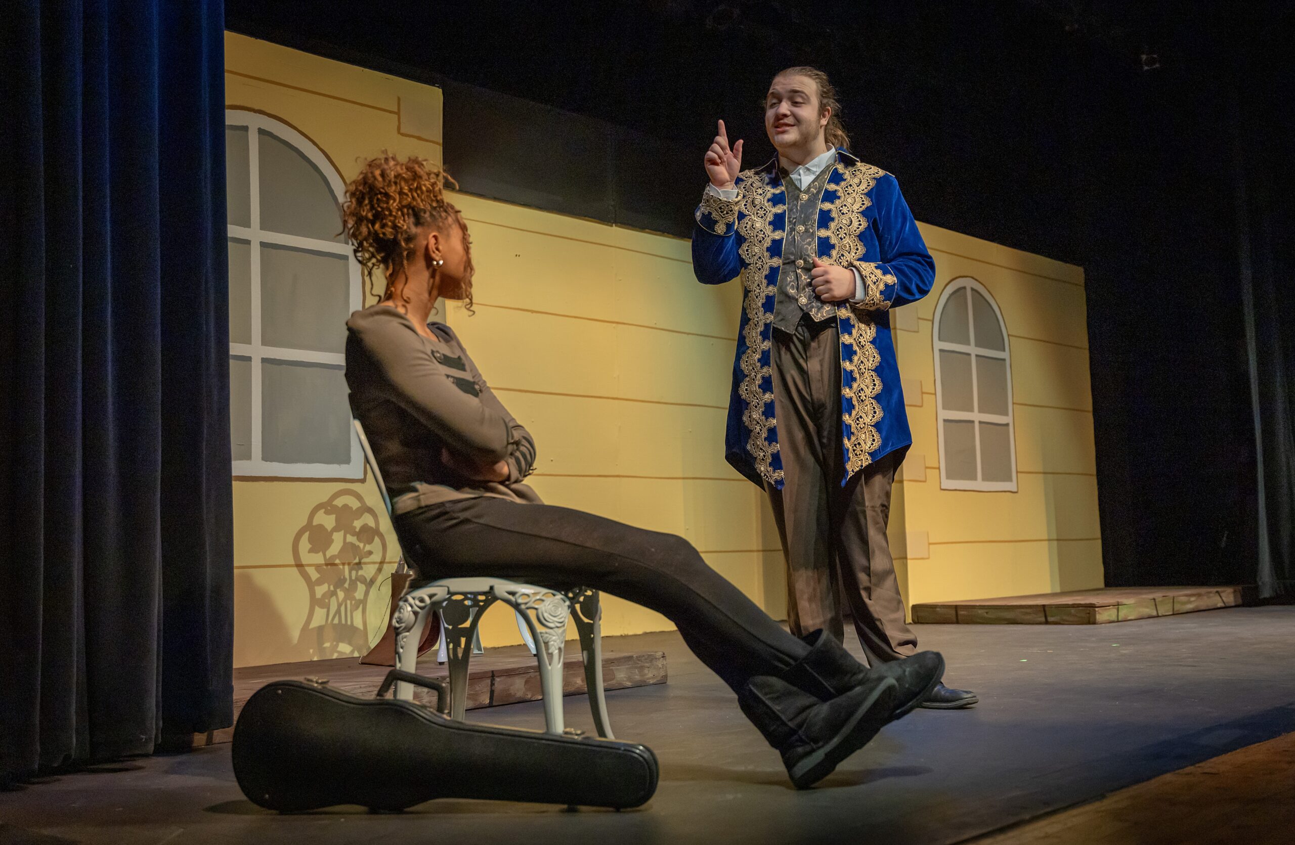 two actors conversing on stage