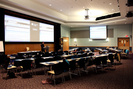 table rows facing a large screen