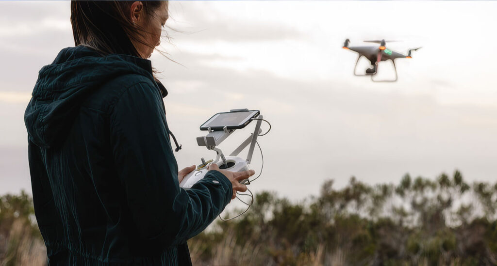 Woman controlling drone in the sky