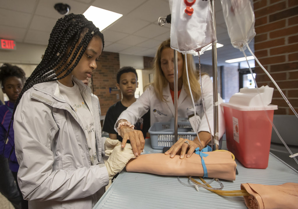 Girl and nurse at medical table