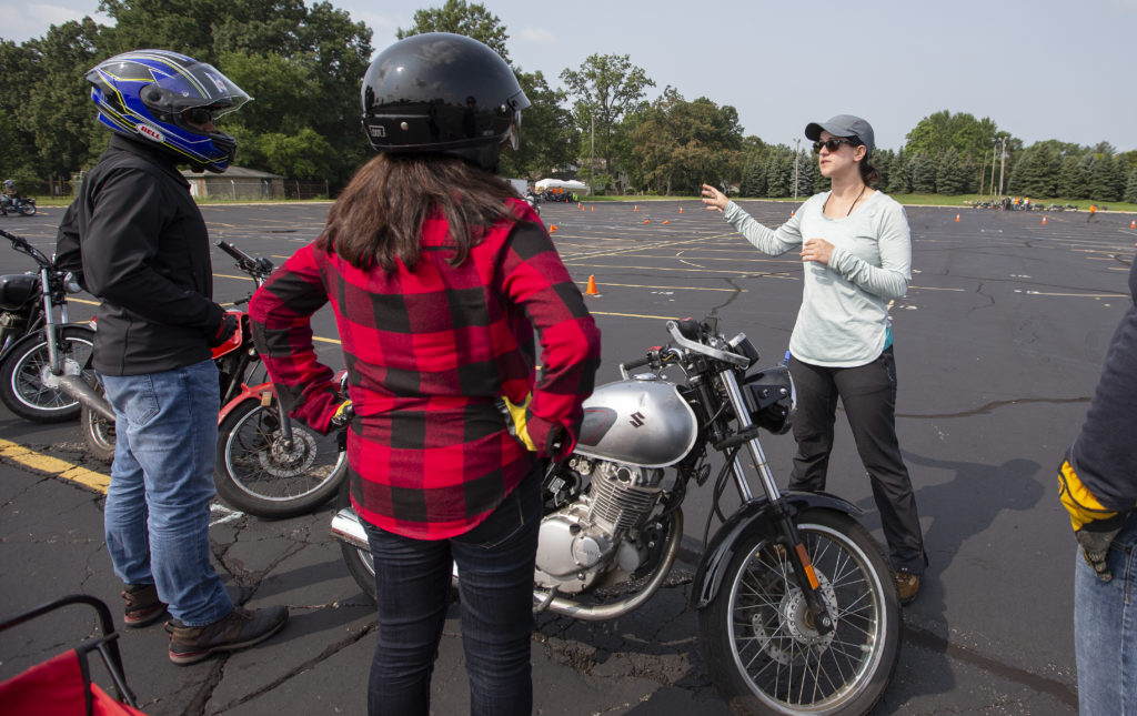 Motorcyclists listening to instruction