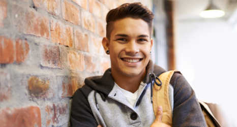 student wearing backpack smiling