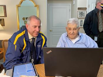 Two men looking at large computer screen