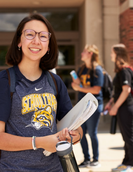 student holding books