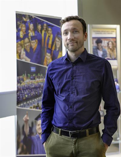 Man standing, smiling at camera