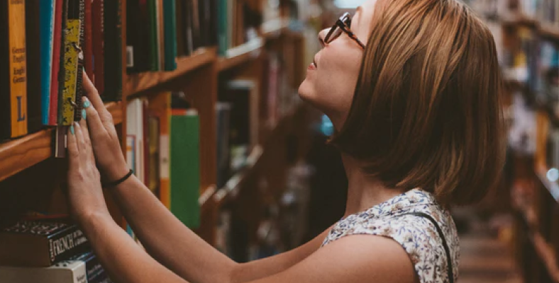 Person looking at a bookshelf