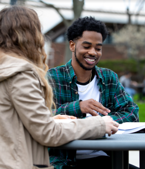 Schoolcraft Detroit Community College - Two students sitting outside at a table