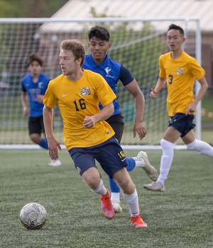 Soccer player dribbling the ball on field