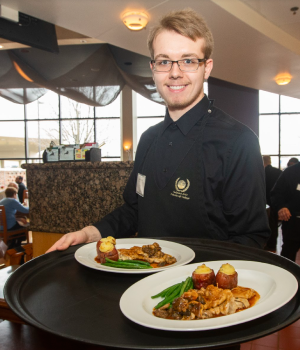 Waiter holding plates