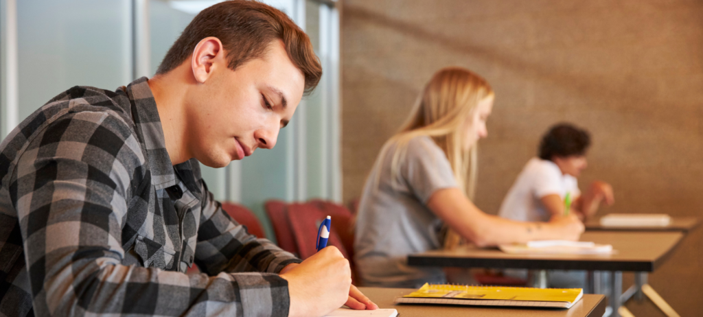 Students writing at desks