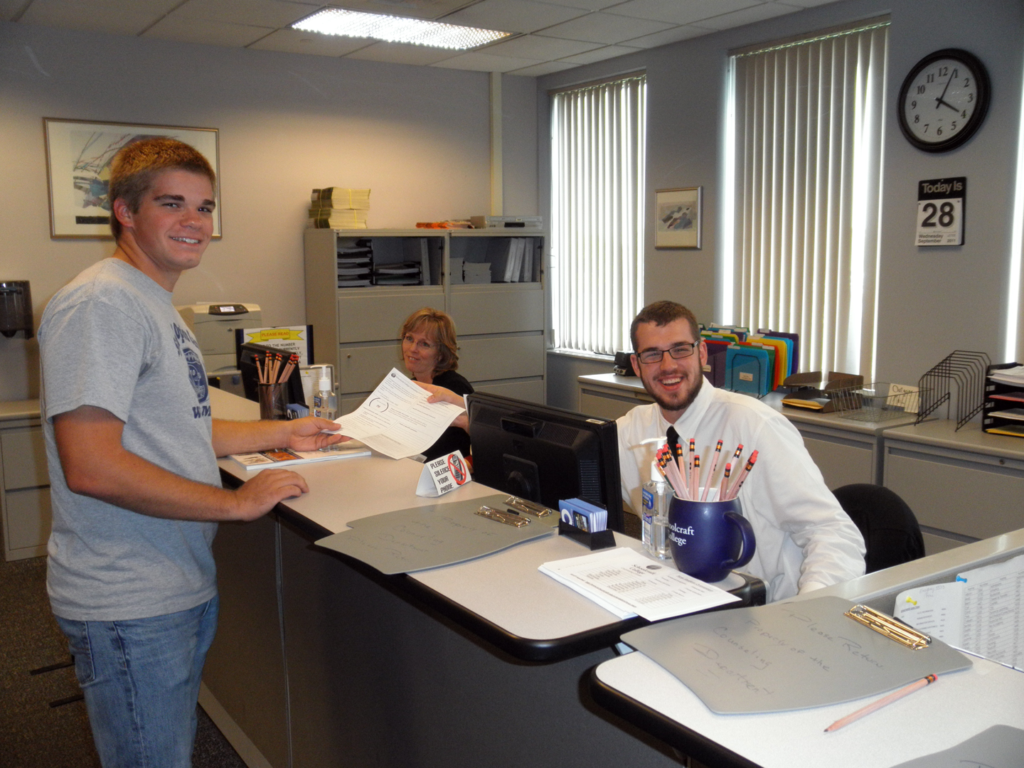 Student hands from to faculty member