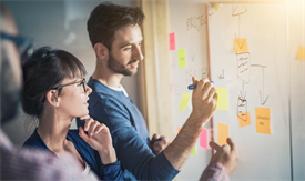A team writing on a whiteboard