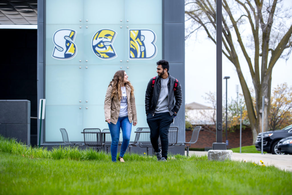 Two students standing in front of bookstore sign