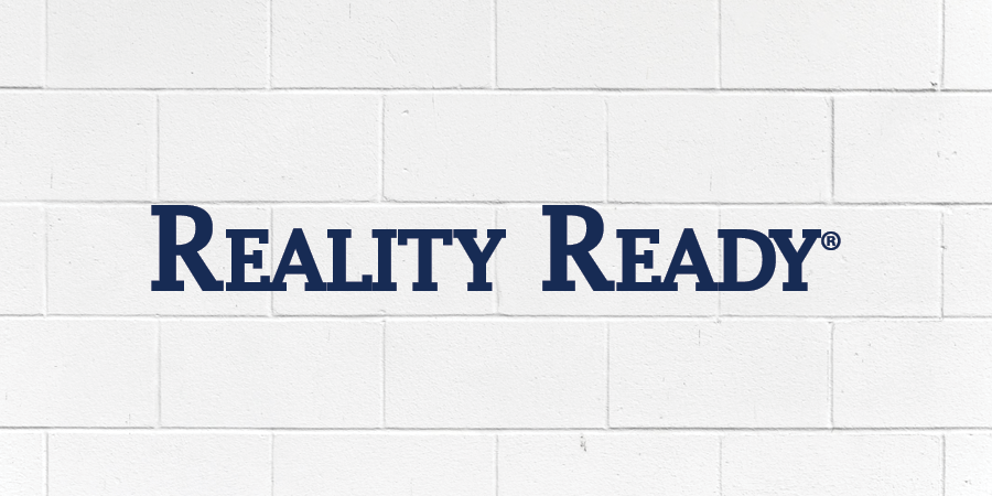 The words "reality ready" with a white brick wall as a backdrop