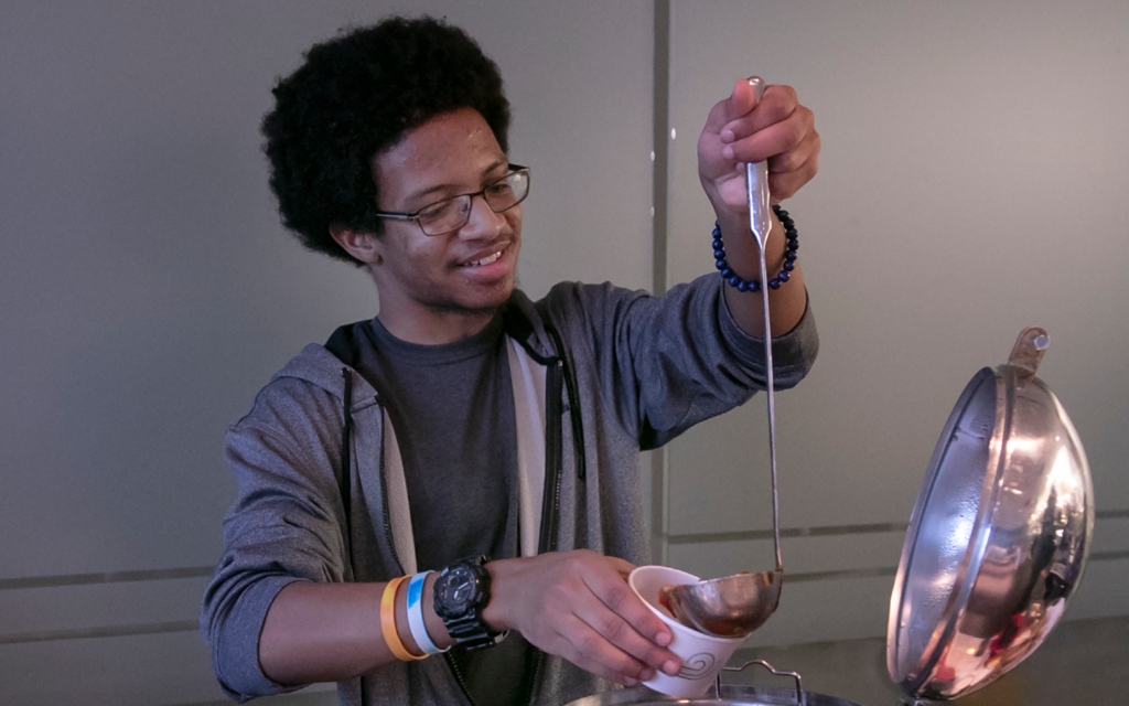 Someone pouring soup into a bowl