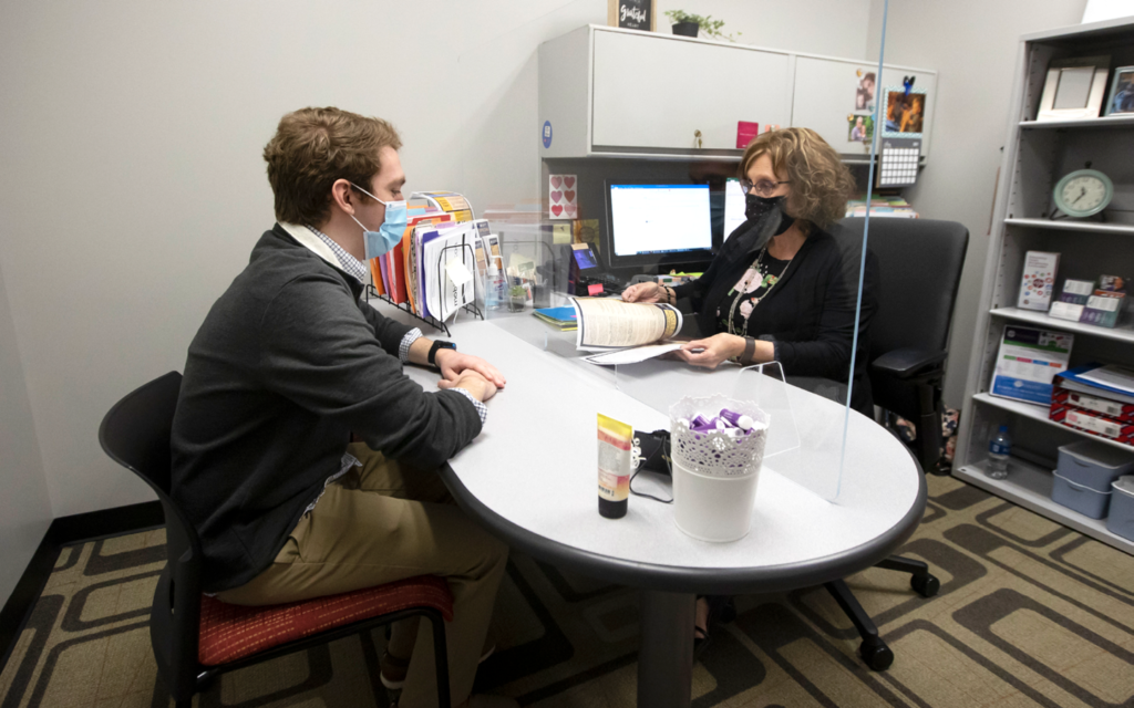 Student receiving guidance in an office