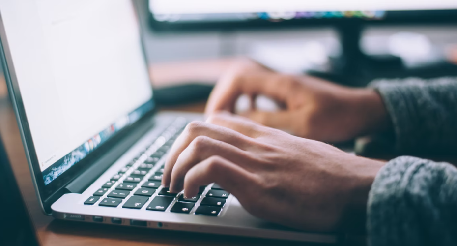 Person typing on a laptop