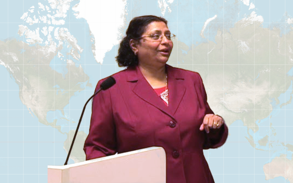 Dr. Arifa Javed with a map of the globe in the background